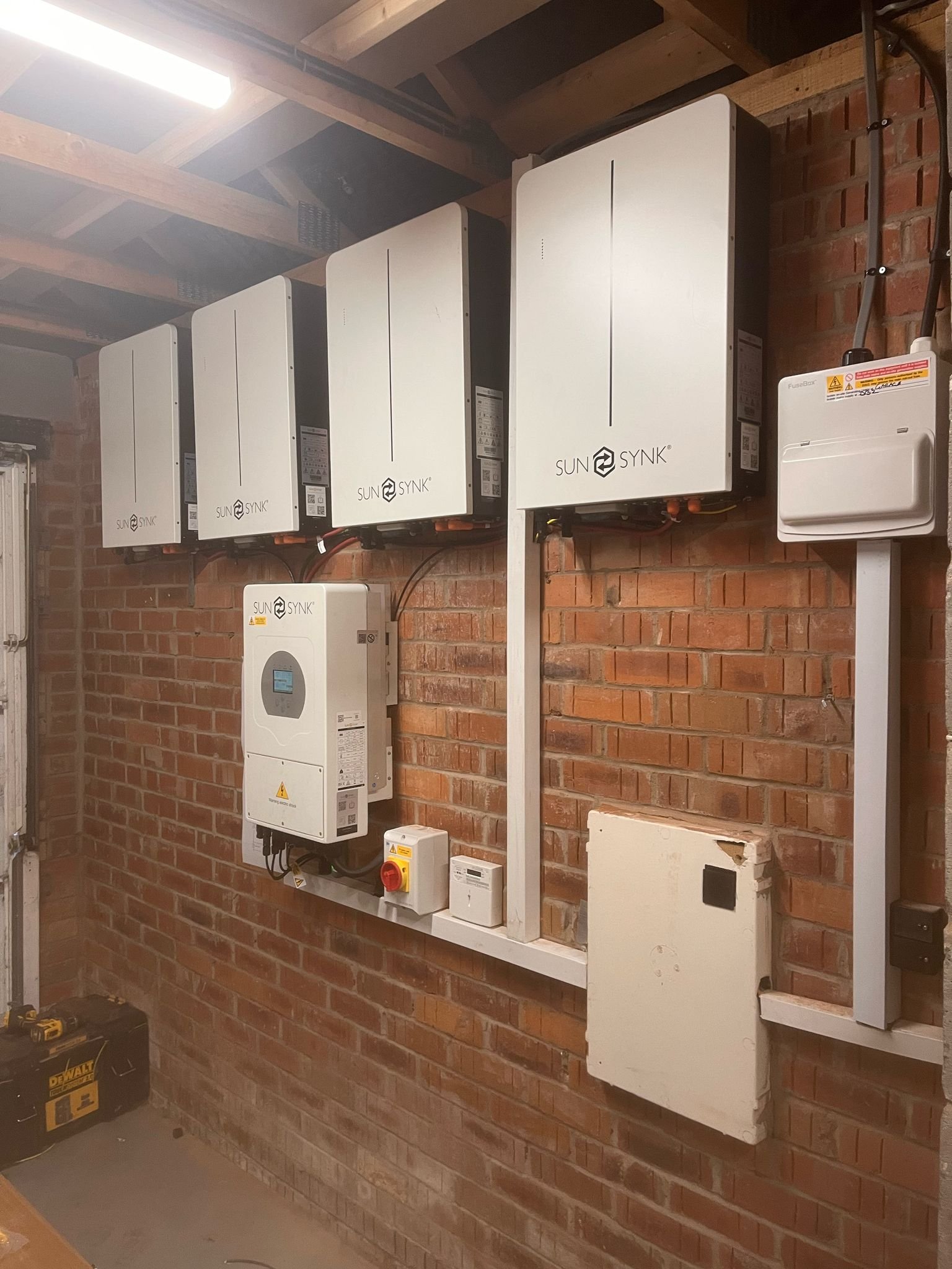 Domestic solar battery and inverter installed neatly inside a UK home.